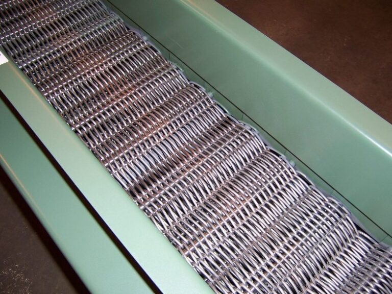 Stainless steel wire mesh conveyor belt running in a painted conveyor frame